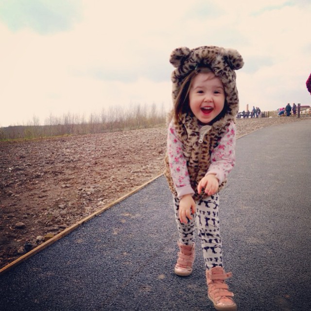 toddler outside, wearing furry gilet with ears