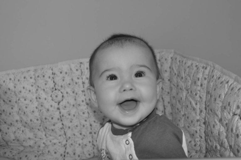 baby with big smile in black and white