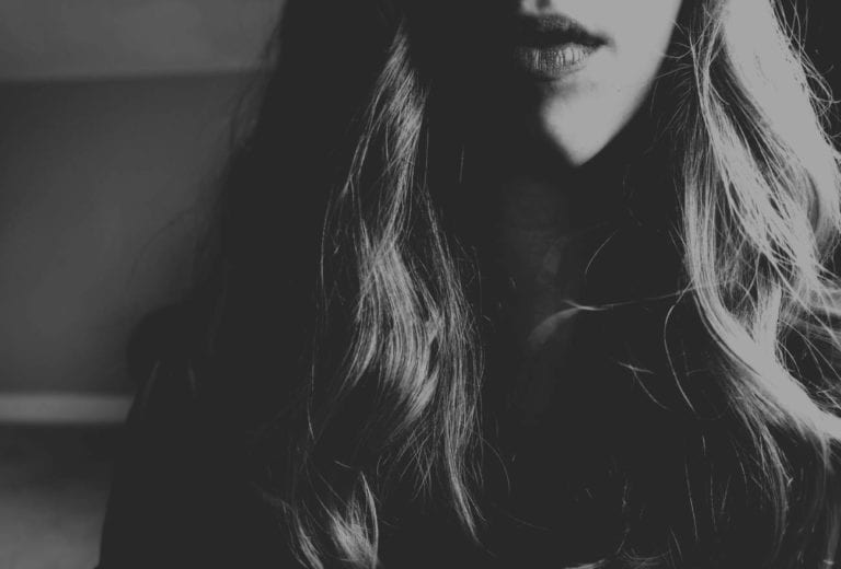 black and white ohoto of woman with long hair up close