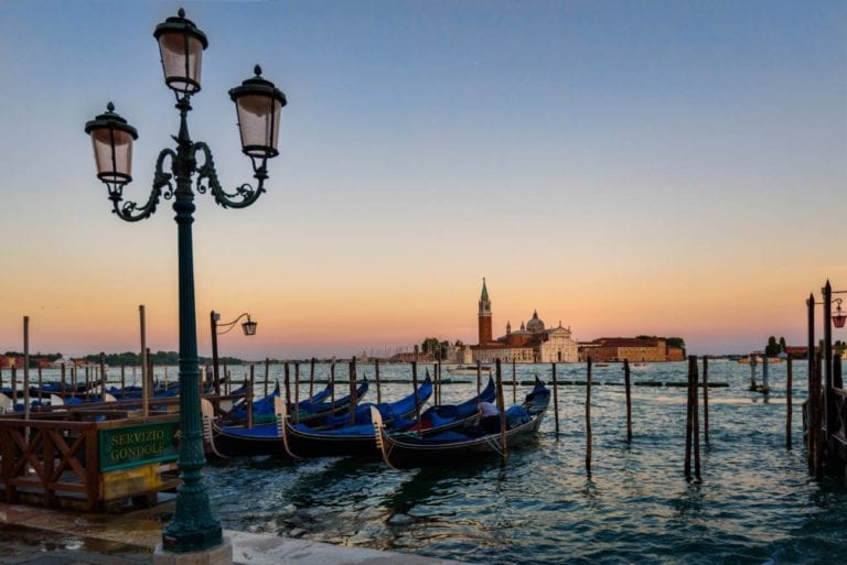 gondolas in water at sunset in Venice