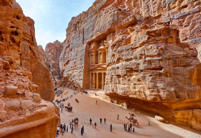 petra in UAE from high up with red rocks and people on the ground