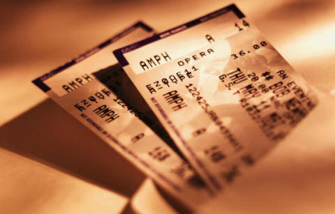brown and white photo of opera tickets