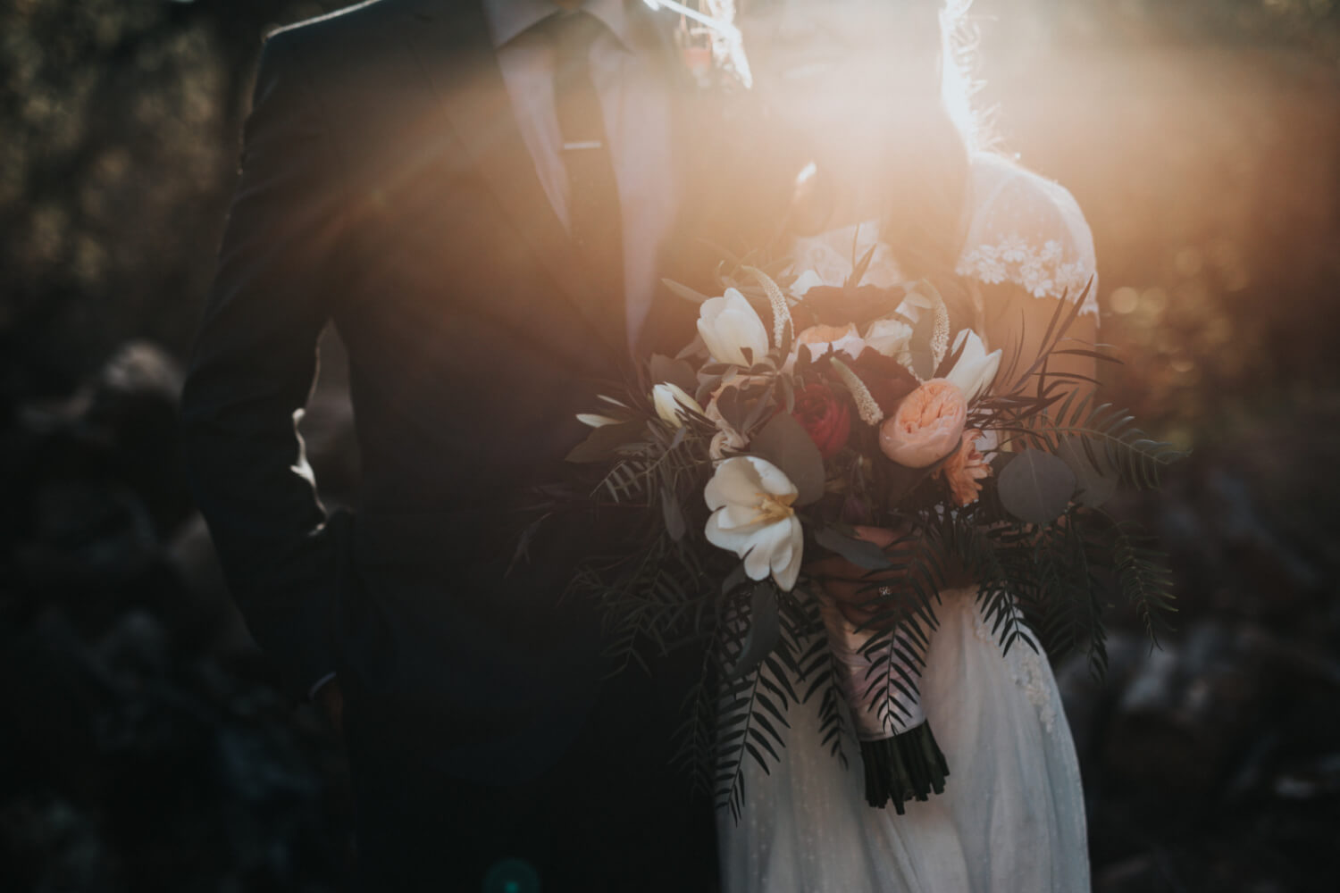 bride and groom up close at golden hour, bride holding bouquet