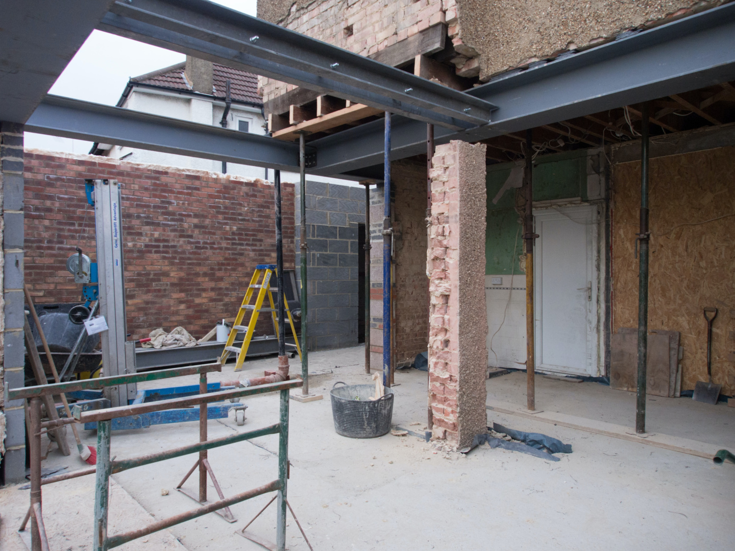 outside of house undergoing renovation and an extension with b brickwork showing