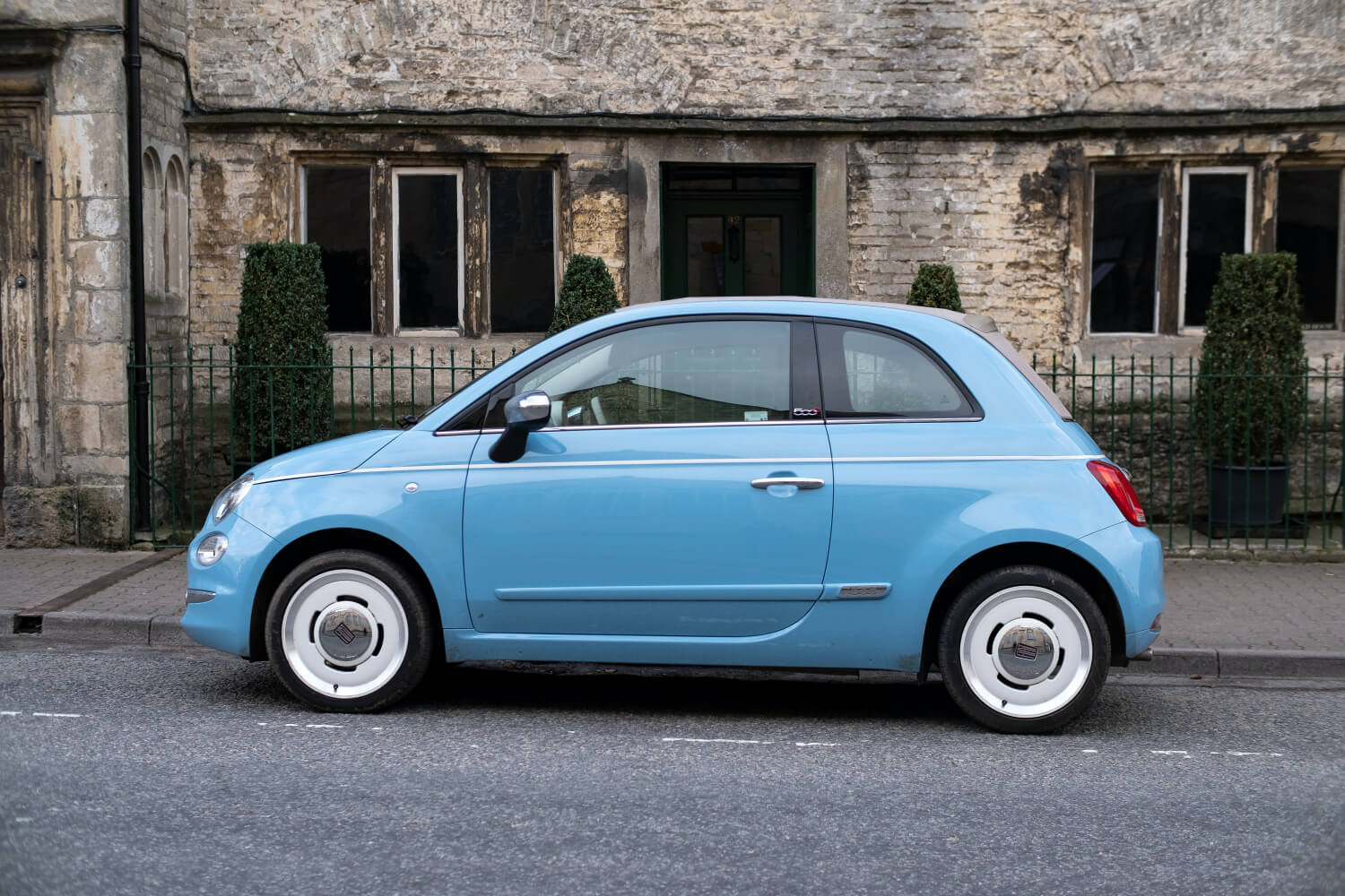 blue car in front of house