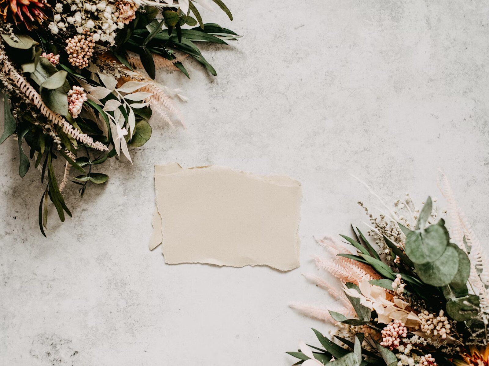 blank piece of paper for wedding invitation and flowers