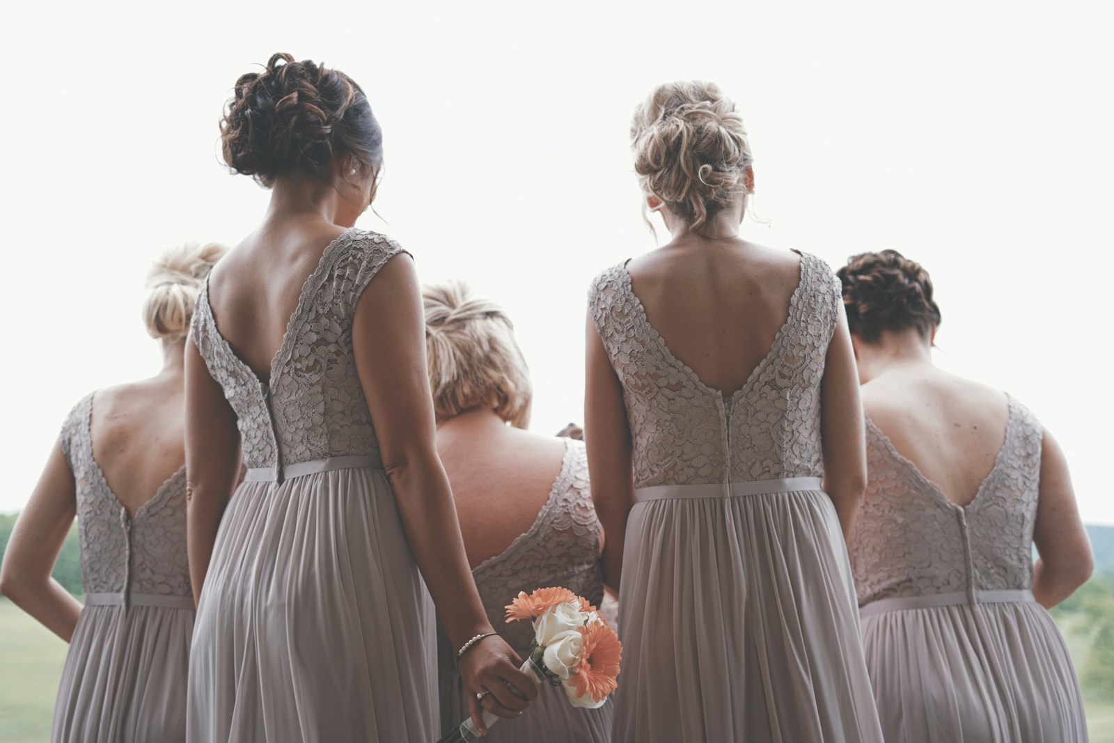 bridesmaids from the back, wearing grey gowns