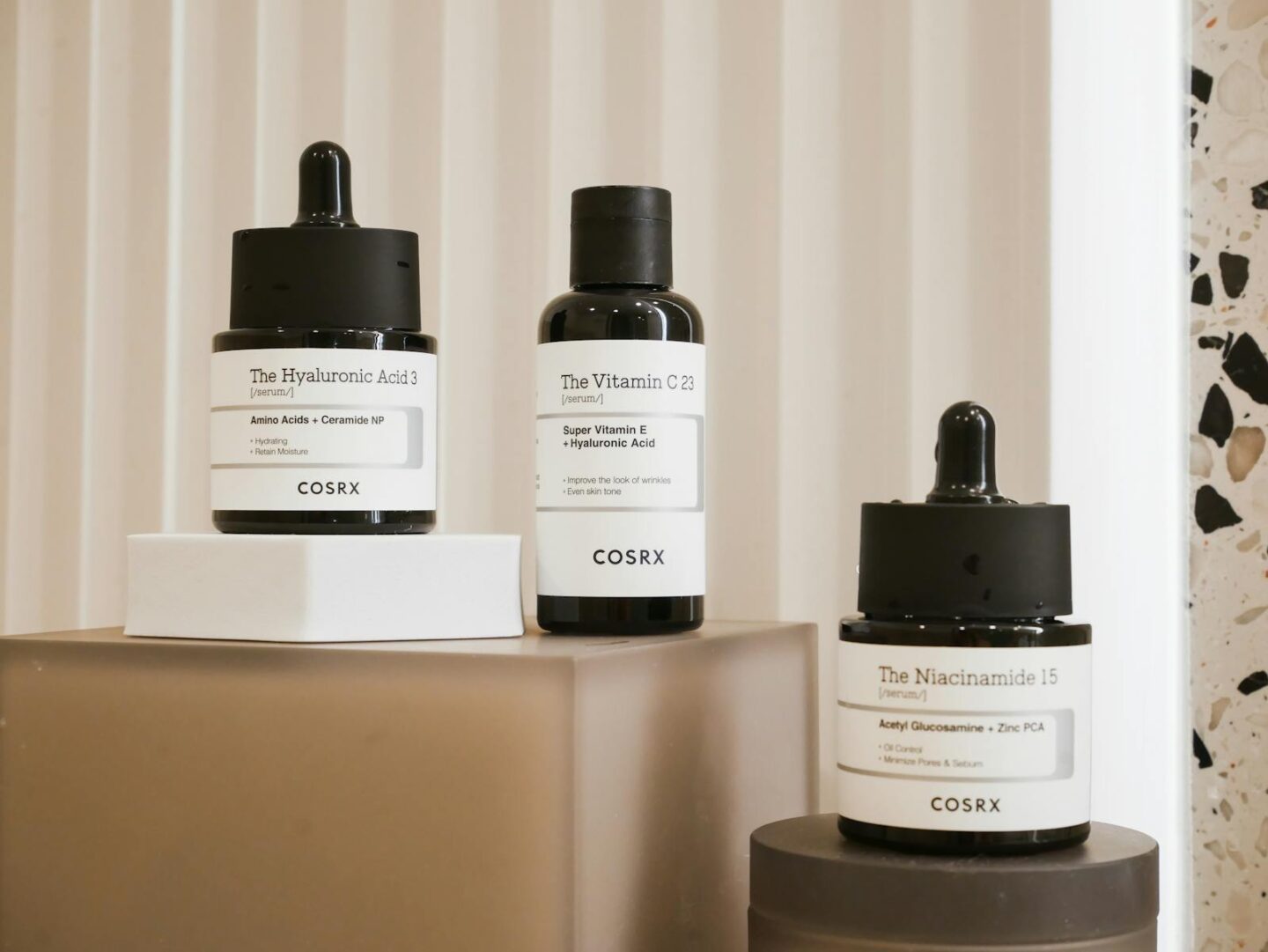 Elegant display of COSRX skincare bottles on a modern backdrop. 