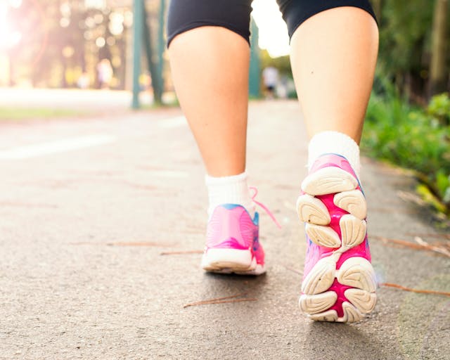 person-running-outside close up of legs in leggings, socks and trainers