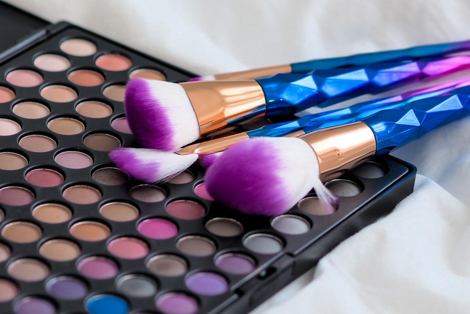 makeup brushes and brightly coloured eyeshadow palette