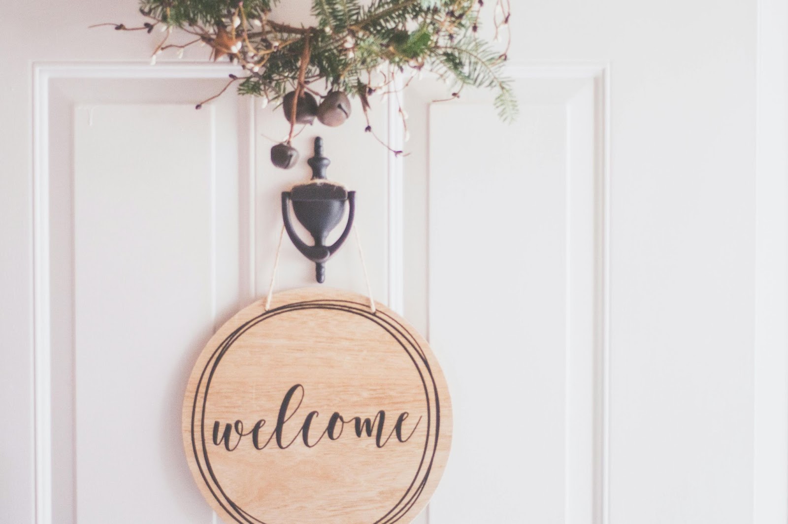 wooden welcome sign on front door