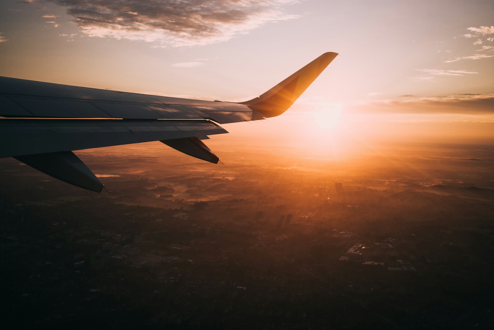 aeroplane wing in the sky during golden hour