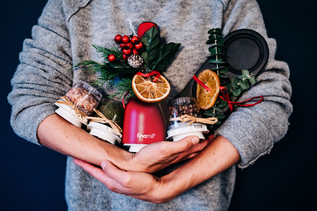 Finamill gift set being held by a woman in her arms with Christmas garnish