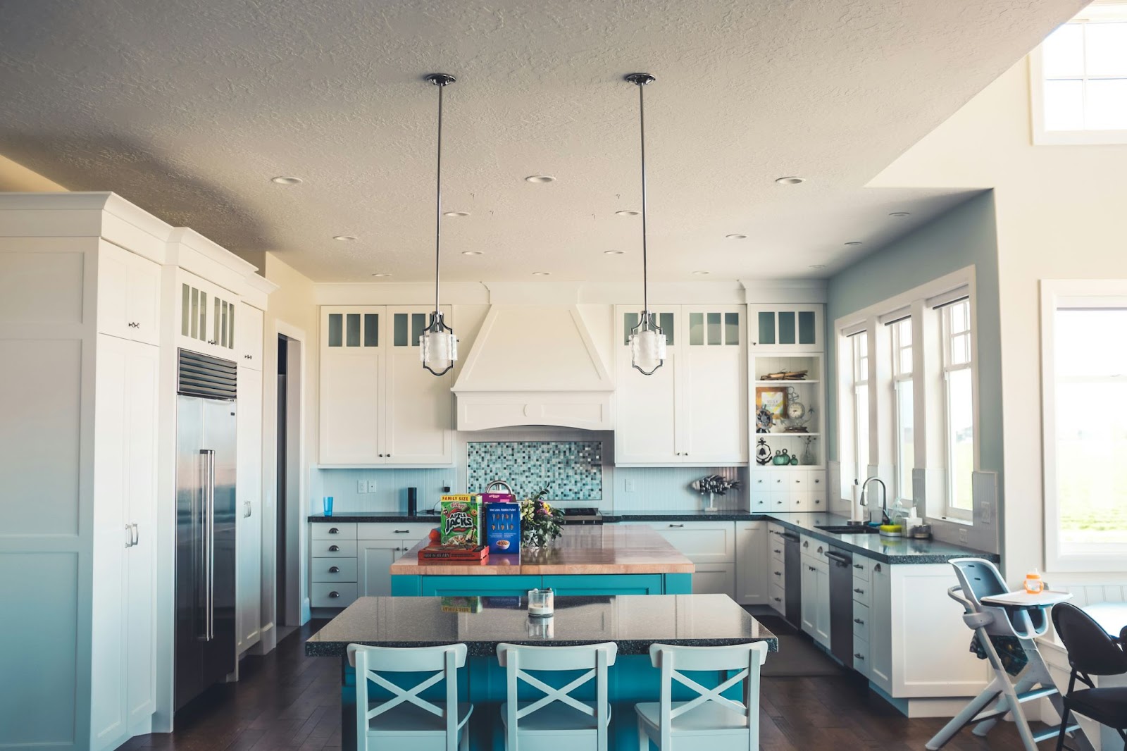 kitchen with island with three stools with cereal boxes on island