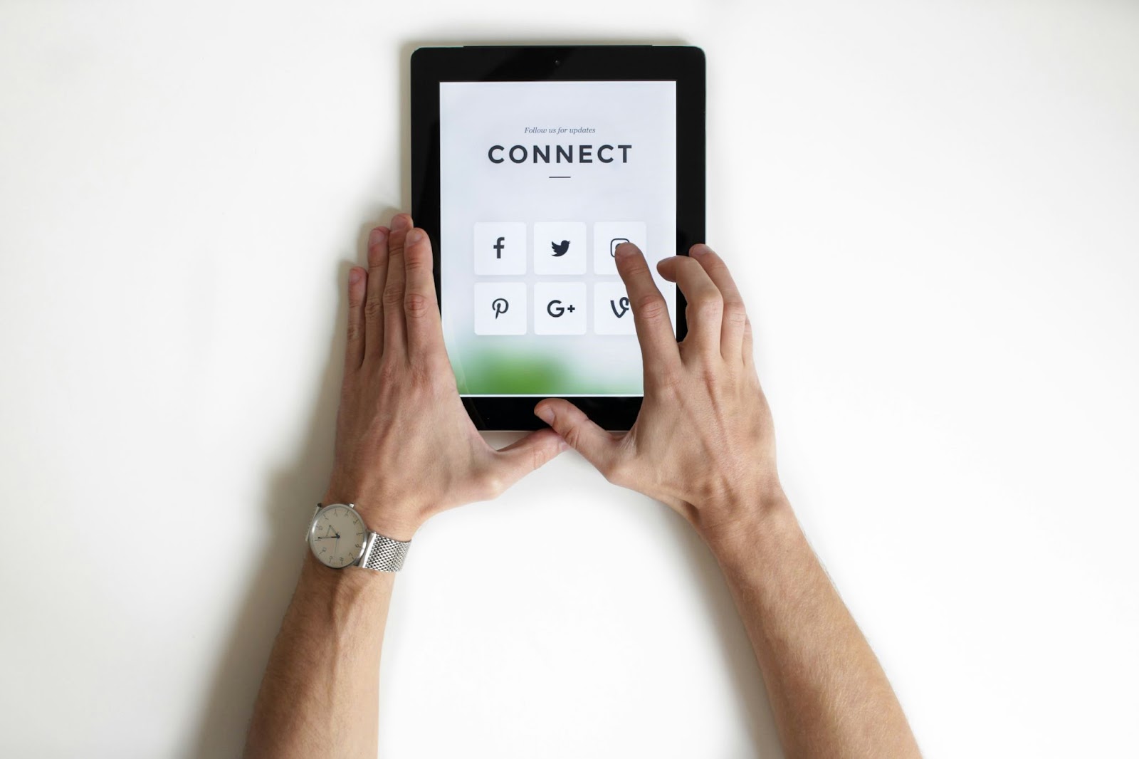 aerial view of hands holding tablet with the words connect on it