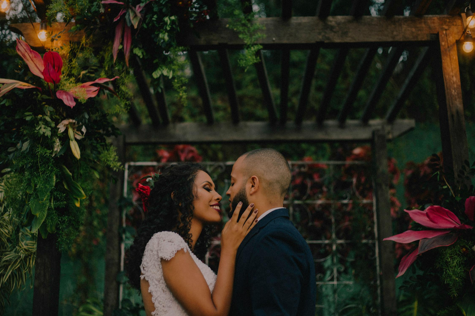 bride and groom smiling, with bride holding man's face