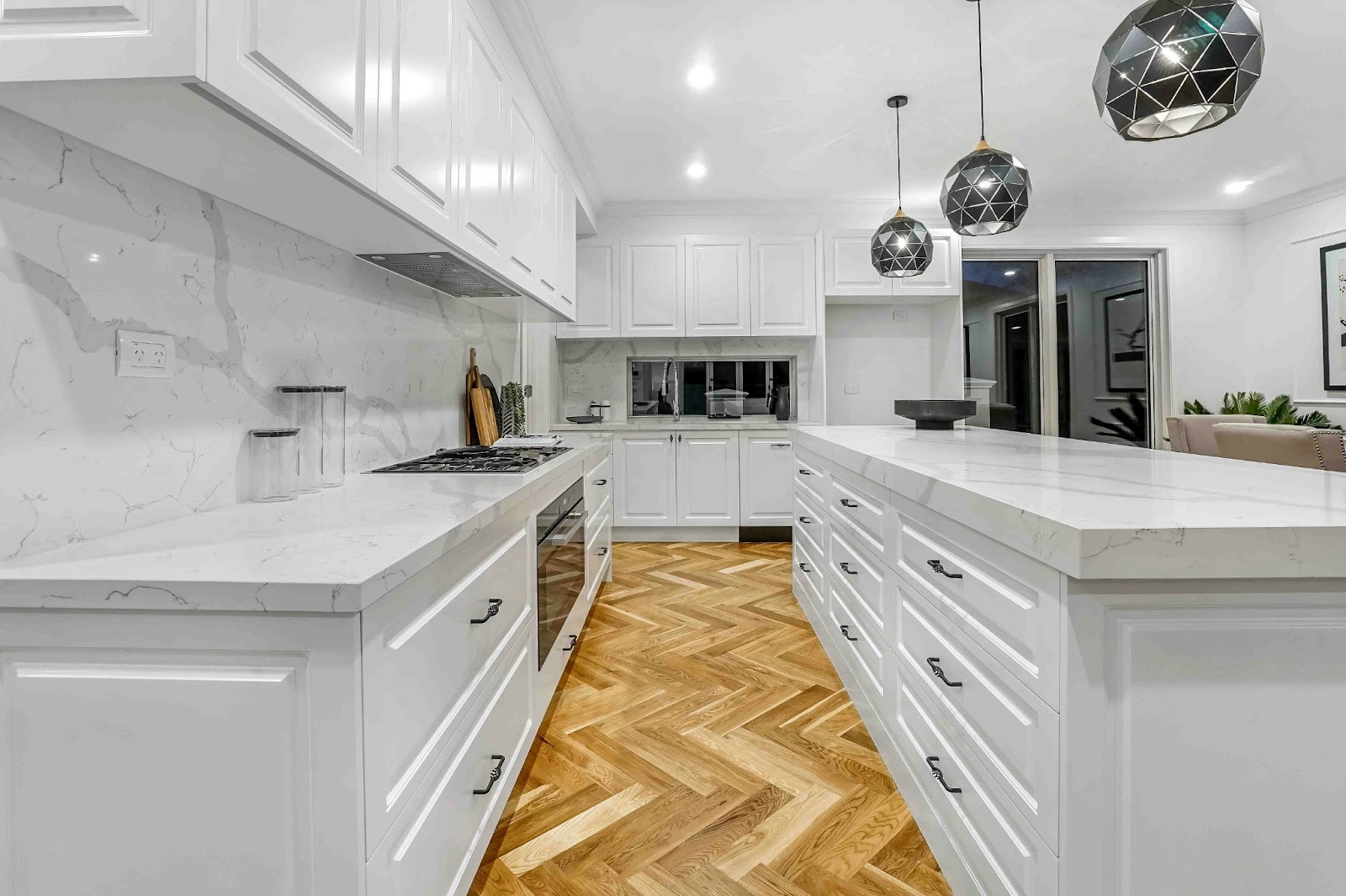 bright white kitchen with parquet flooring