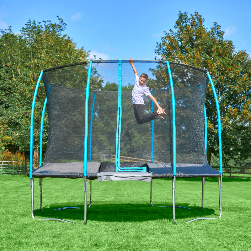 boy jumping up on a trampoline in the garden