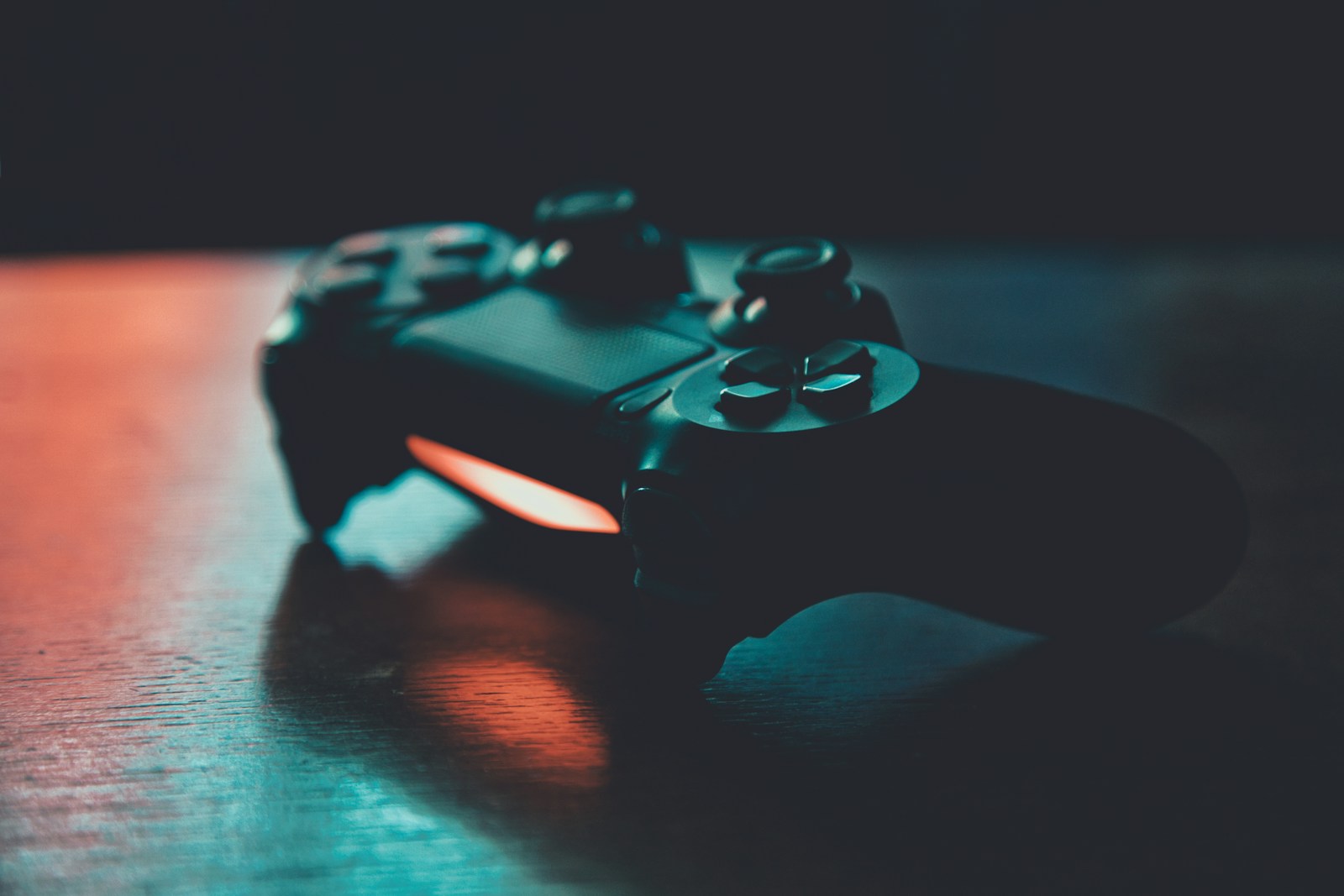 gaming control handset on table in dark light