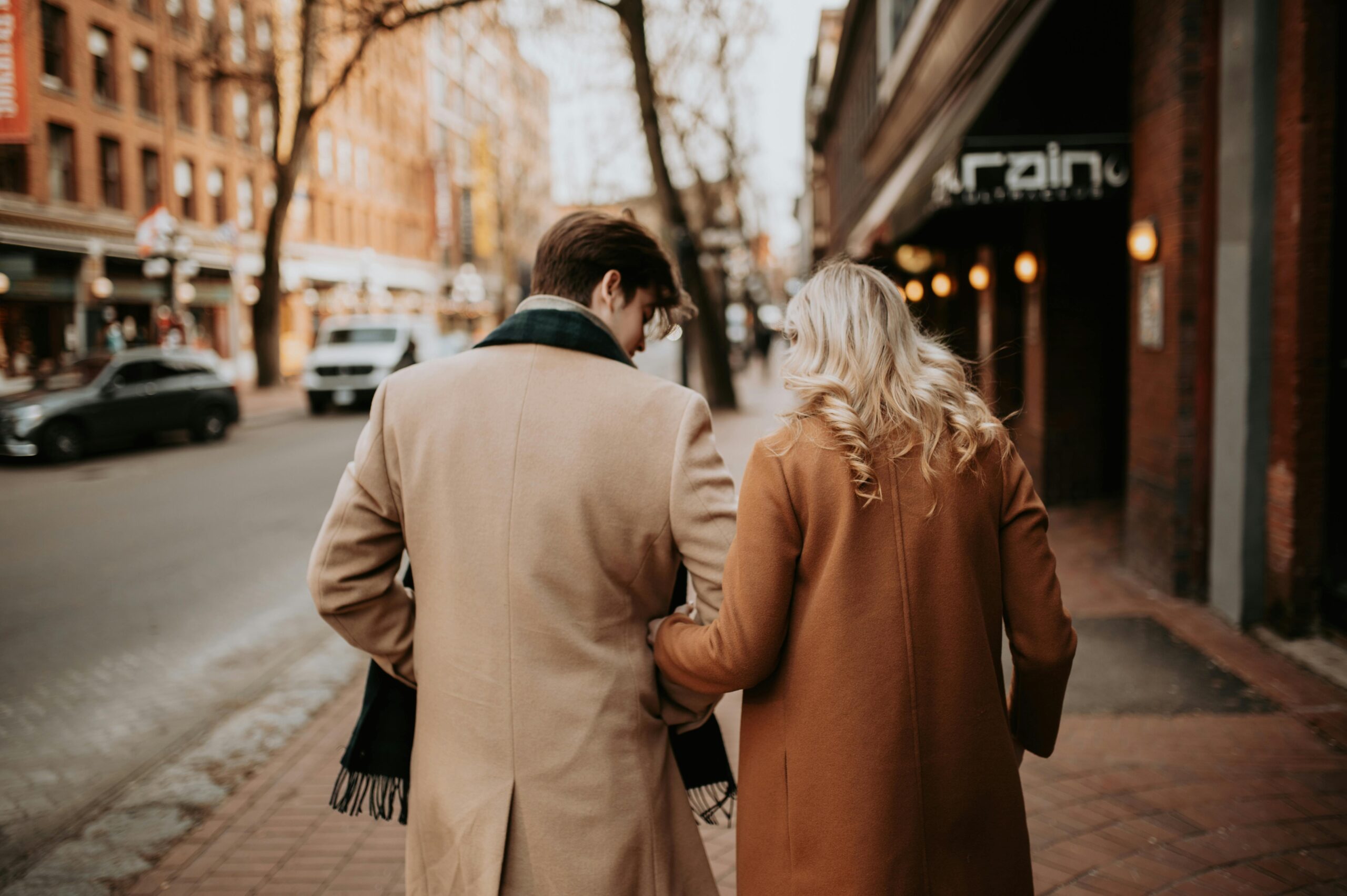 couple walking together outside arm in arm