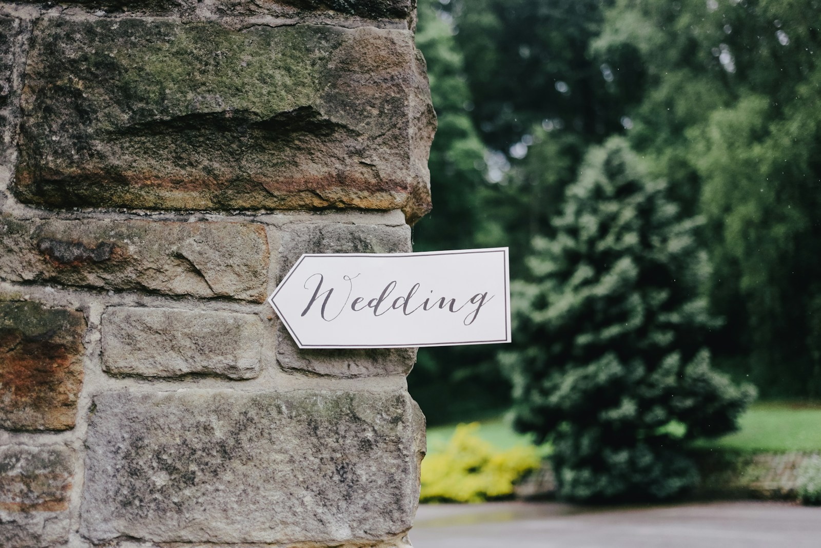 wedding signage on stone wall