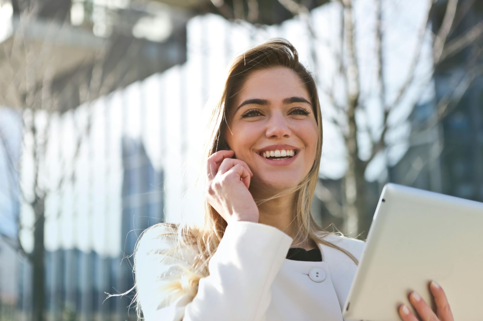 woman on phone outside and smiling