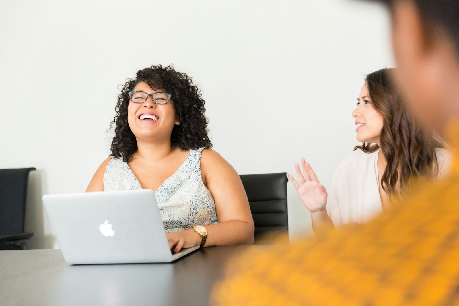 two women smiling in business meeting