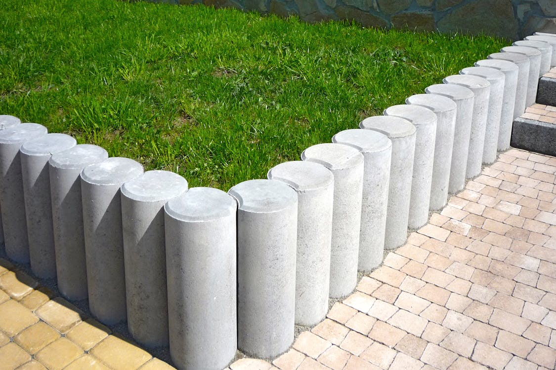 grey paving and grass