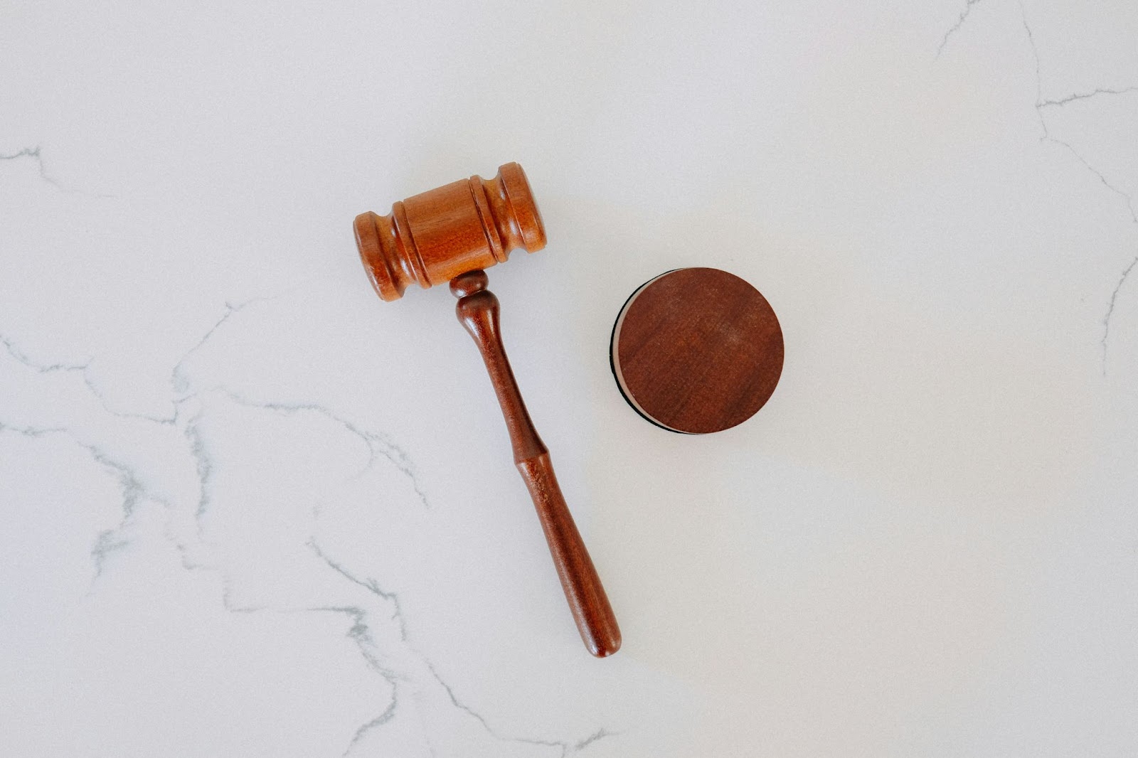 wooden gavel and block on marble surface