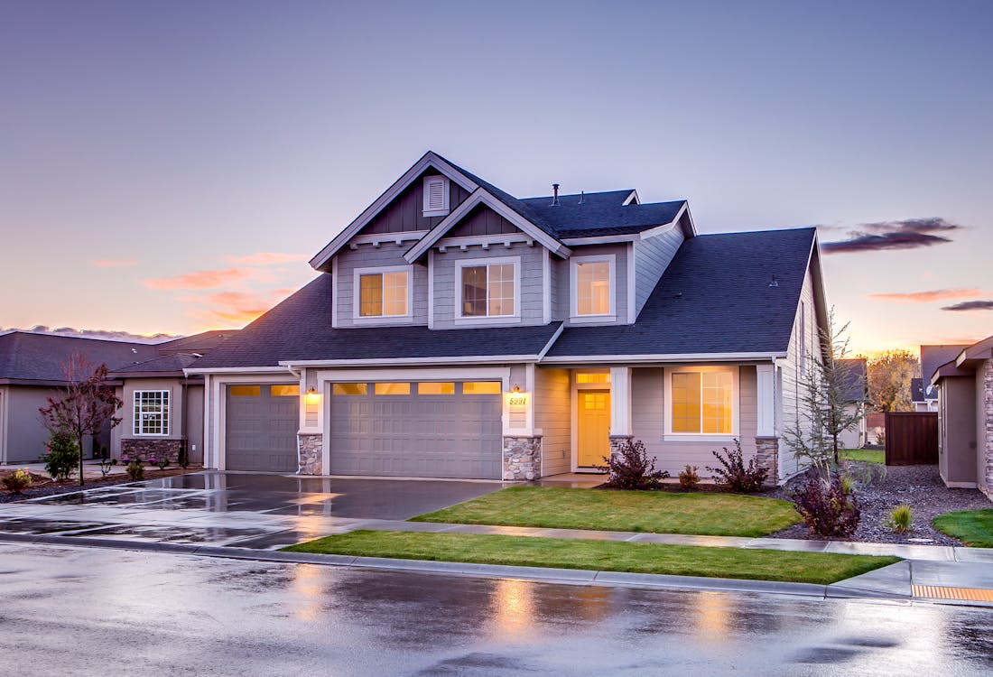 white and grey house on road after rain