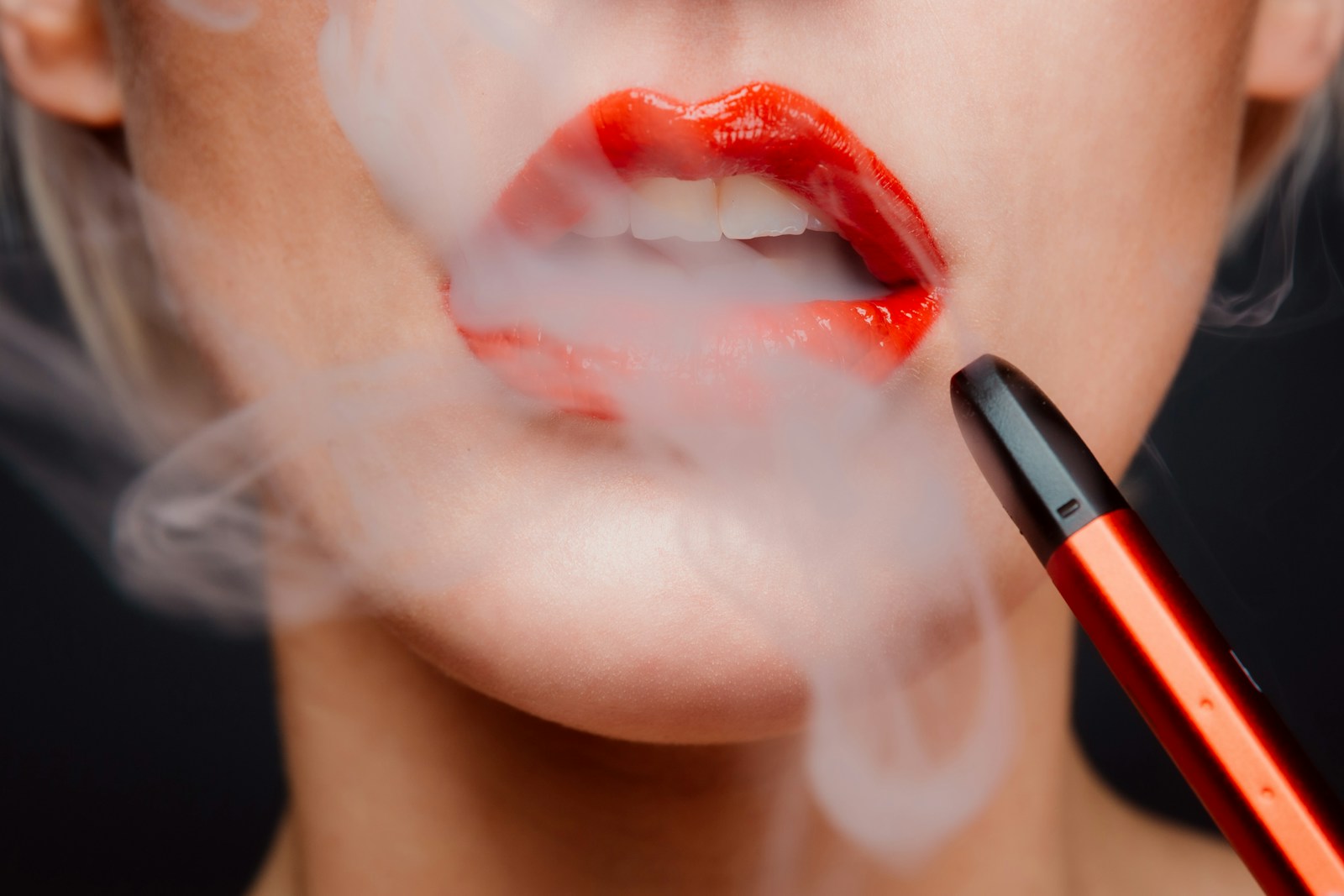 woman with red lipstick and smoke coming out of her mouth