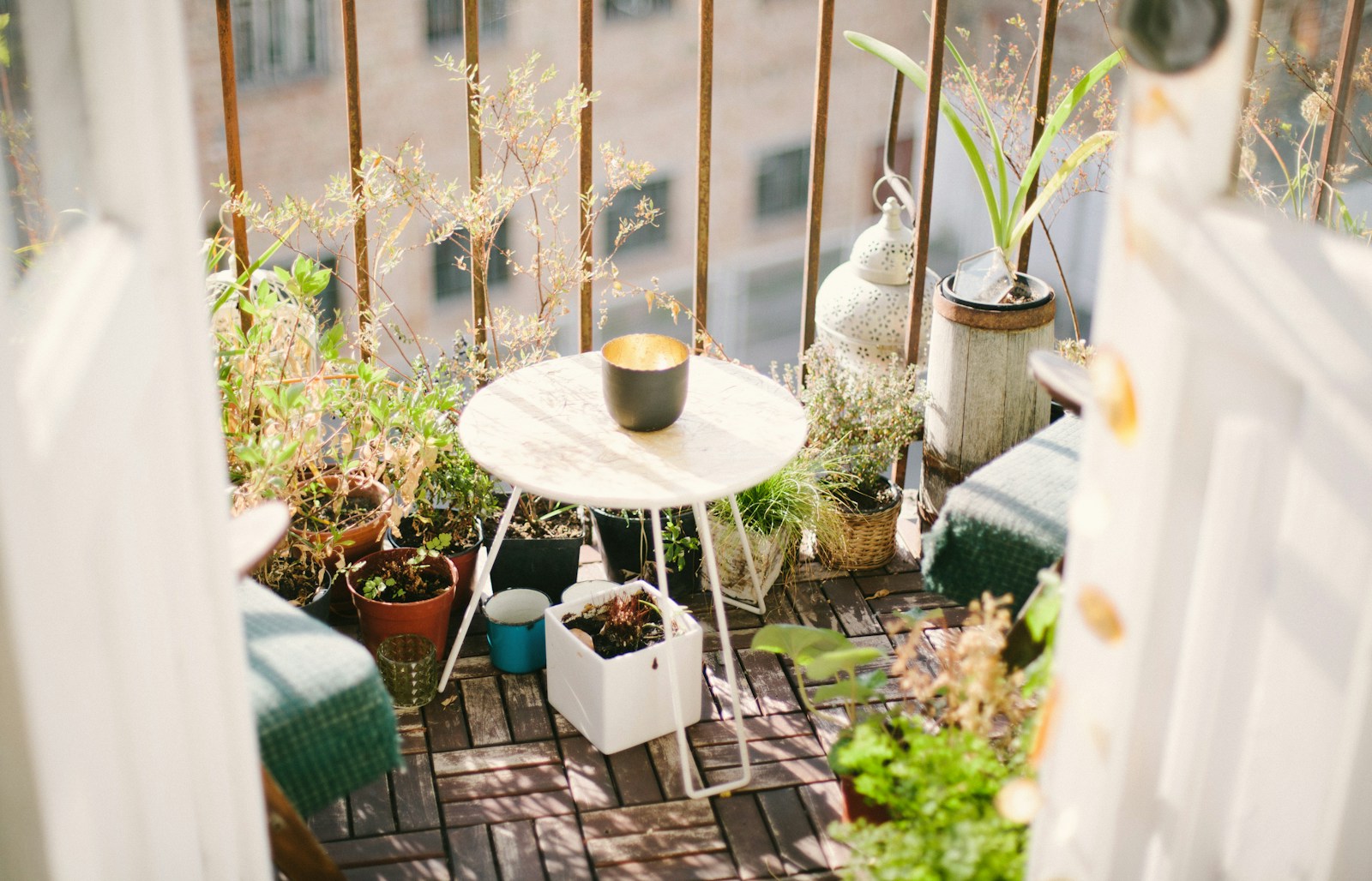 garden on balcony with plants and table during daytime