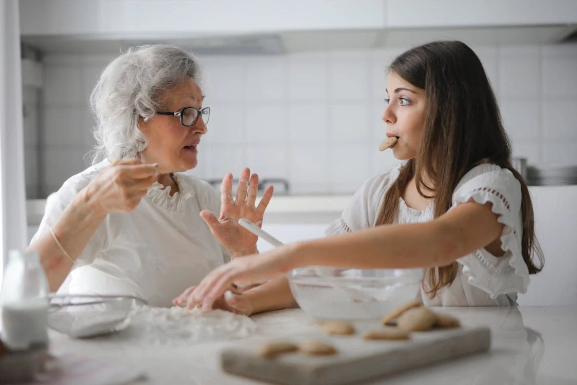 young woman and old woman baking cookies in kitchen