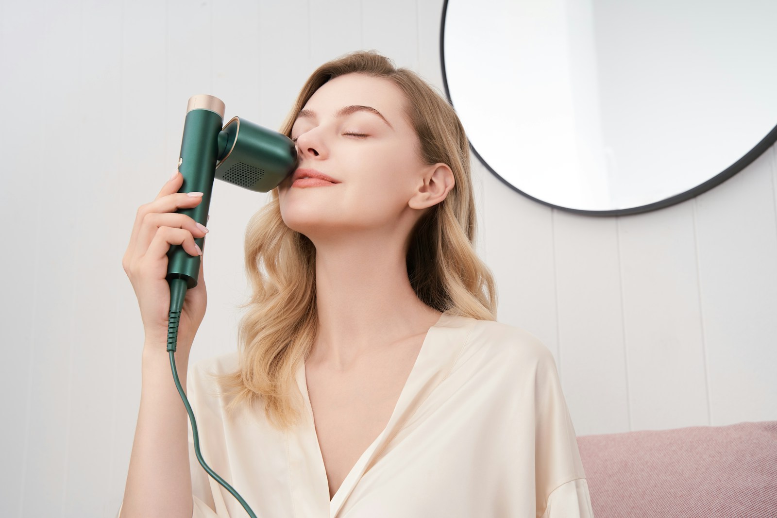 a woman holding a skincare device against her face