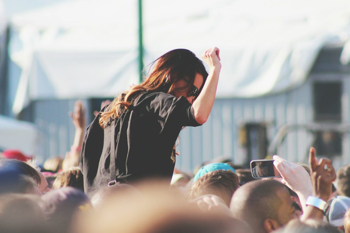 woman on top of crowd at festival