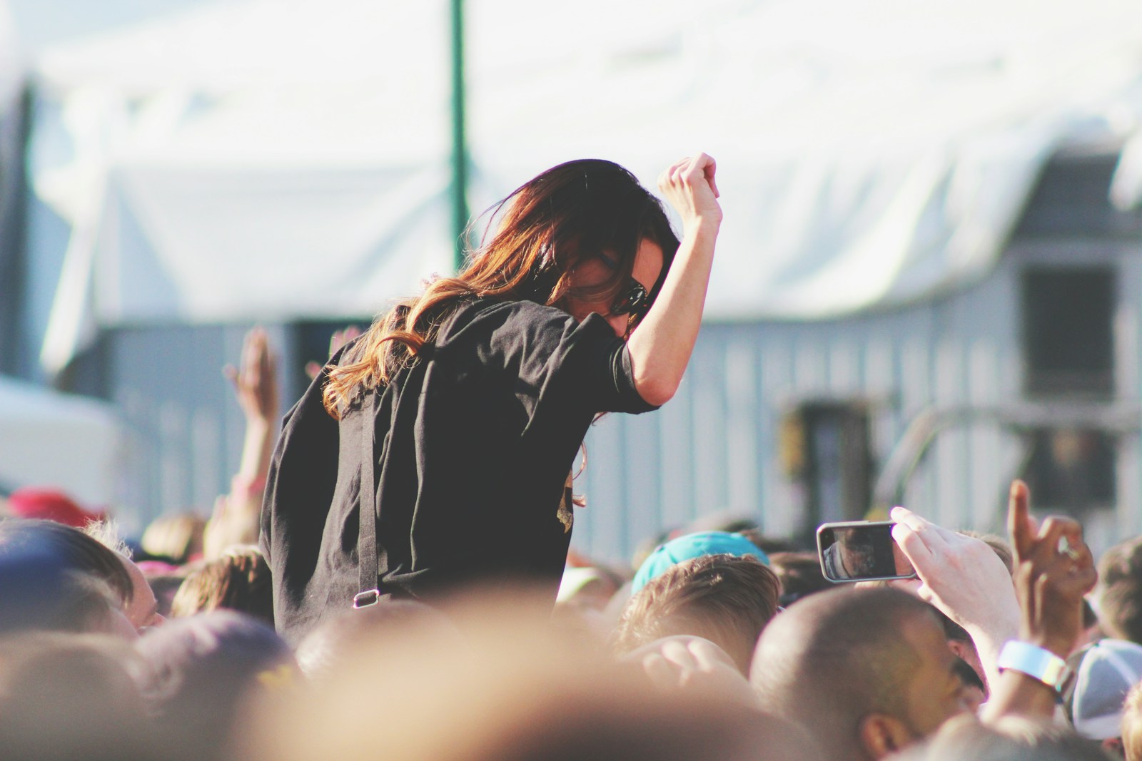 woman on top of crowd at festival