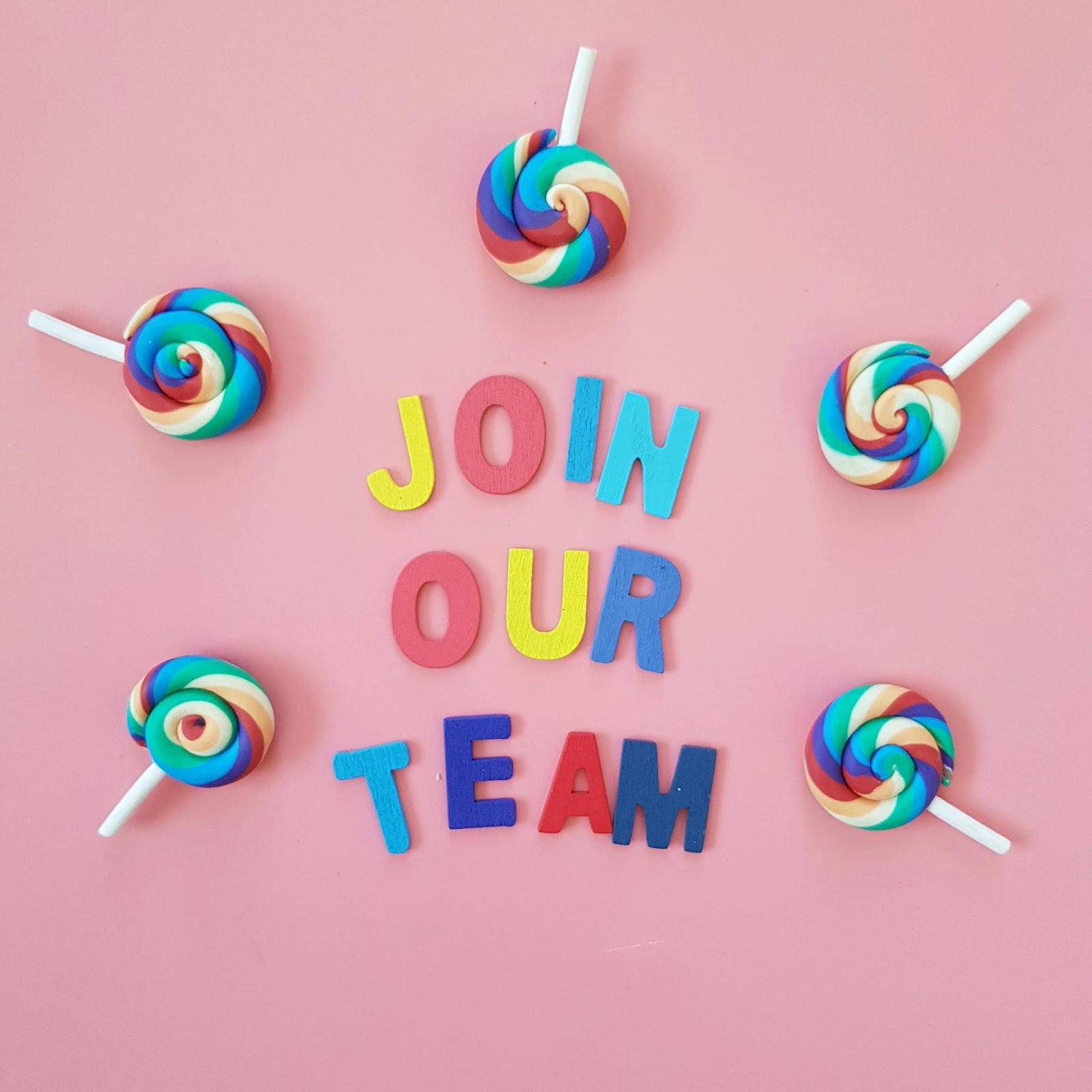 colouring lettering on pink background, saying 'join our team'
