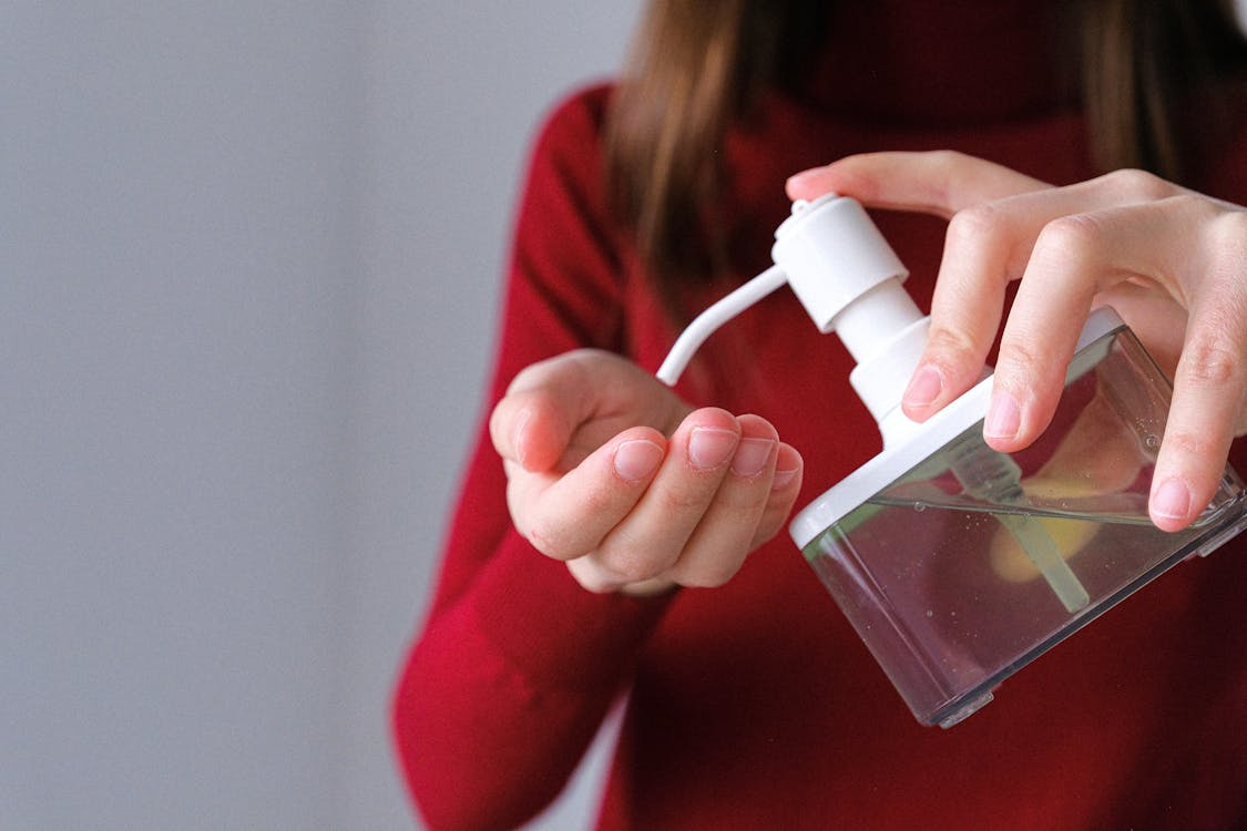 woman squirting liquid into hand