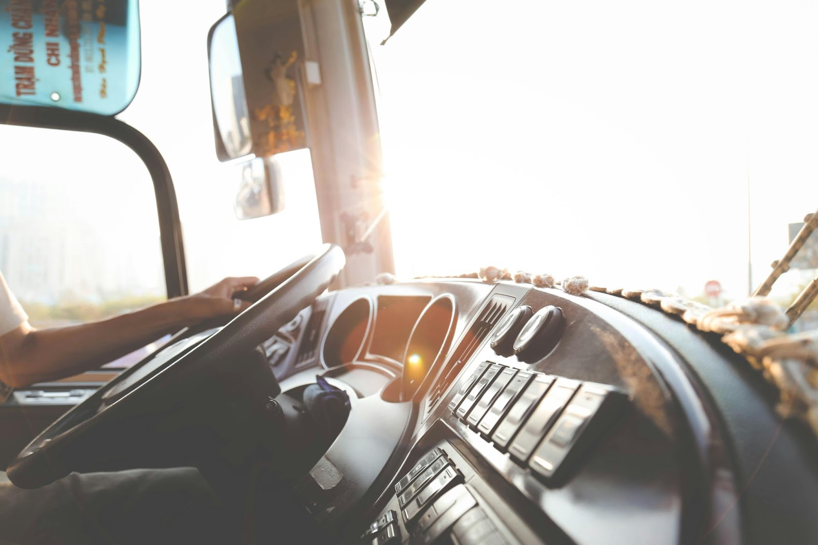 dashboard of a truck with someone holding the steering wheel