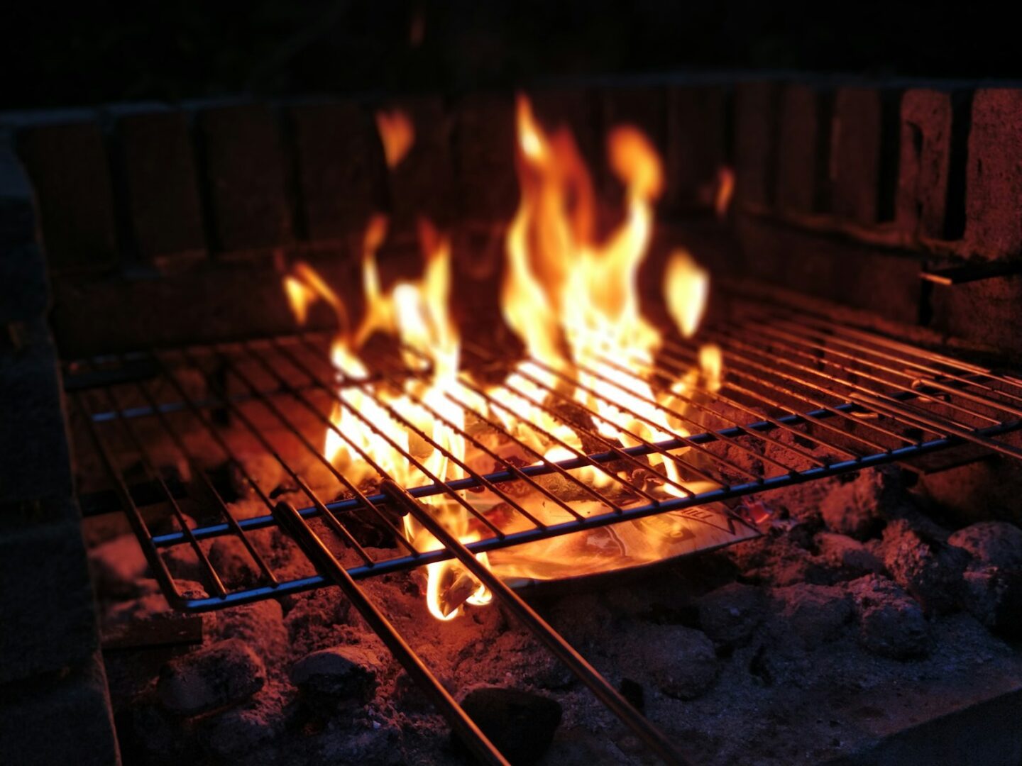 closeup photo of fire on metal grill