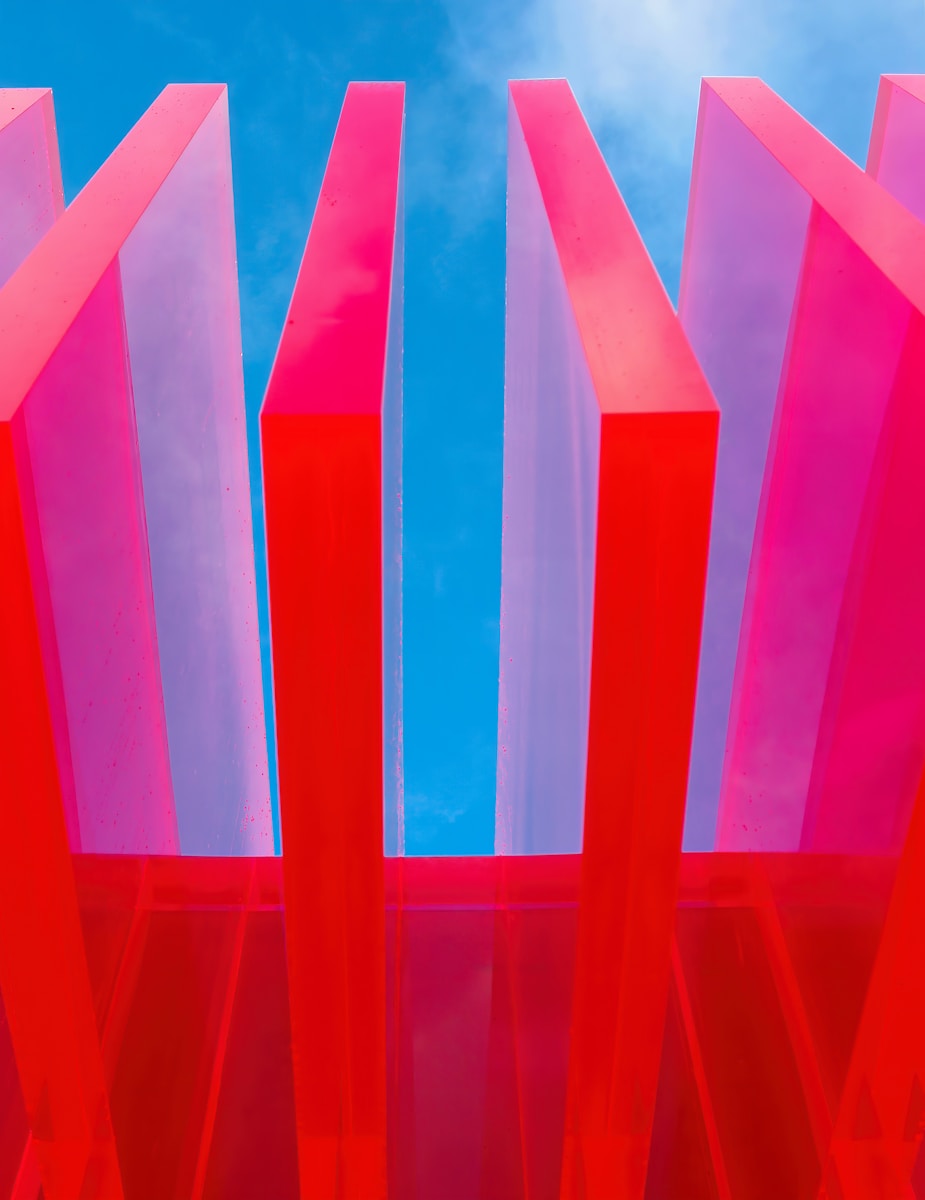 red acrylic blocks in front of bright blue sky