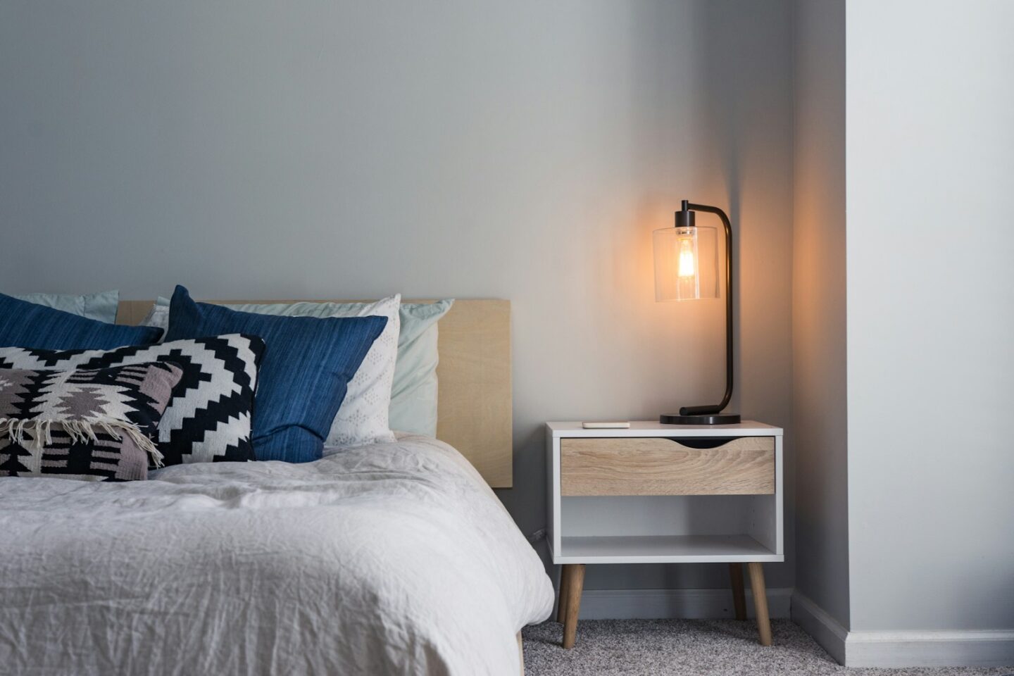 black table lamp on nightstand next to bed in bedroom