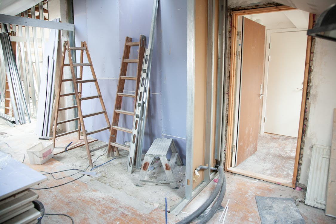 inside of a house being decorated, with ladders
