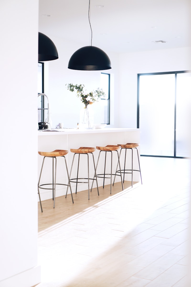 brown bar stools against white kitchen island