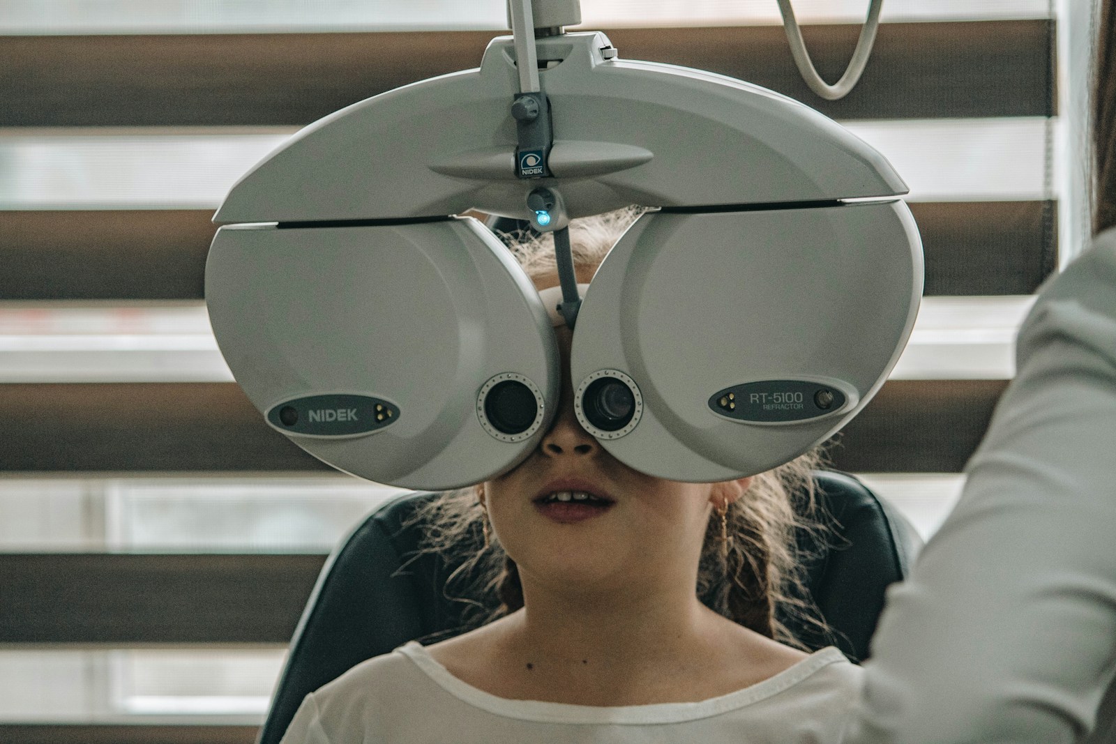 white eye testing machine against child's face