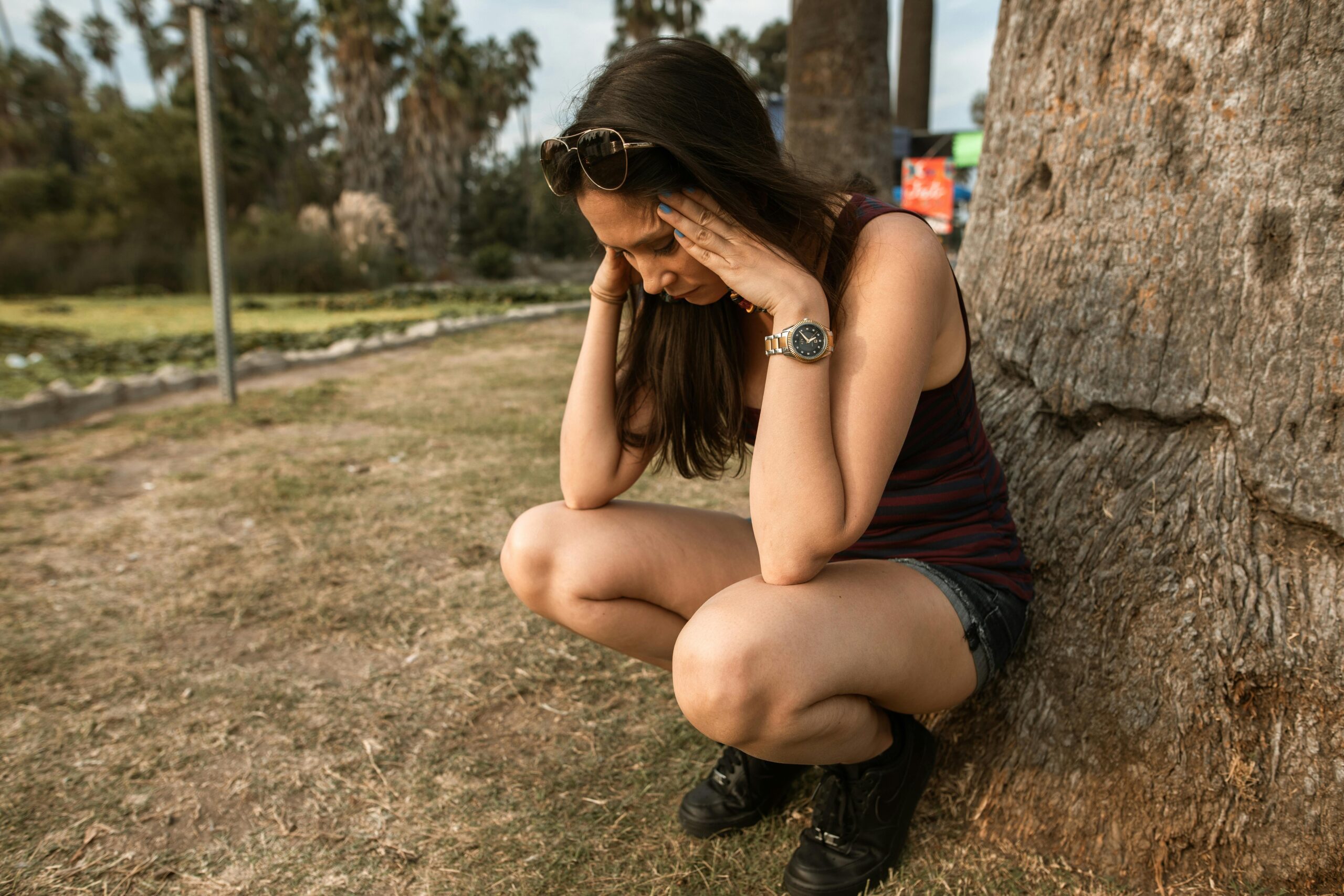 Woman Crouching while Her Hands are on Her Head
