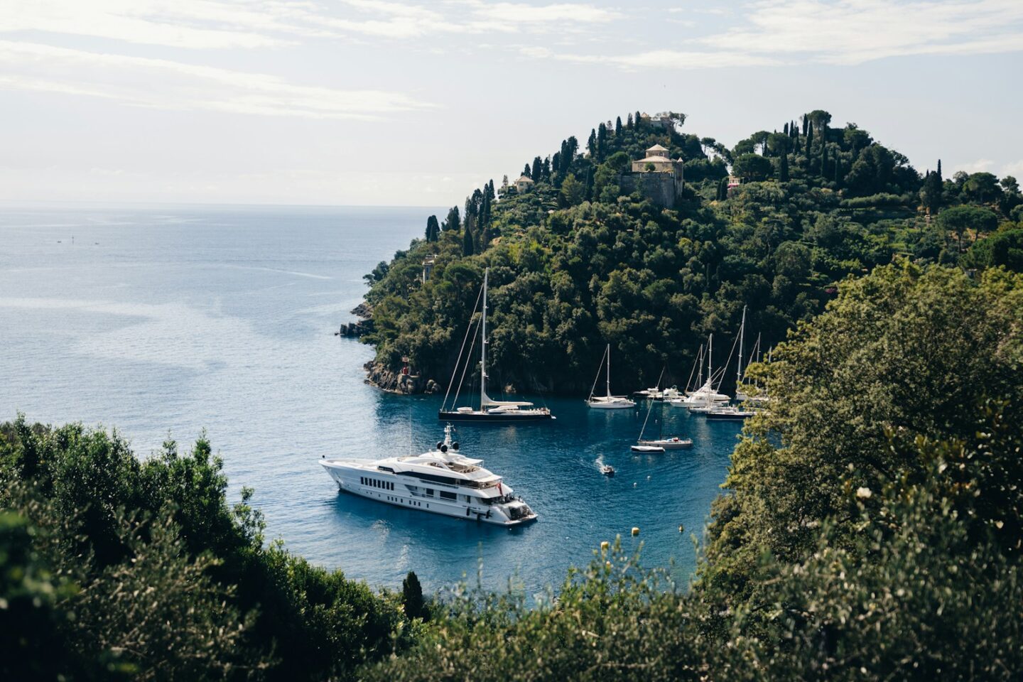 A yacht floating on top of a body of water near other boats