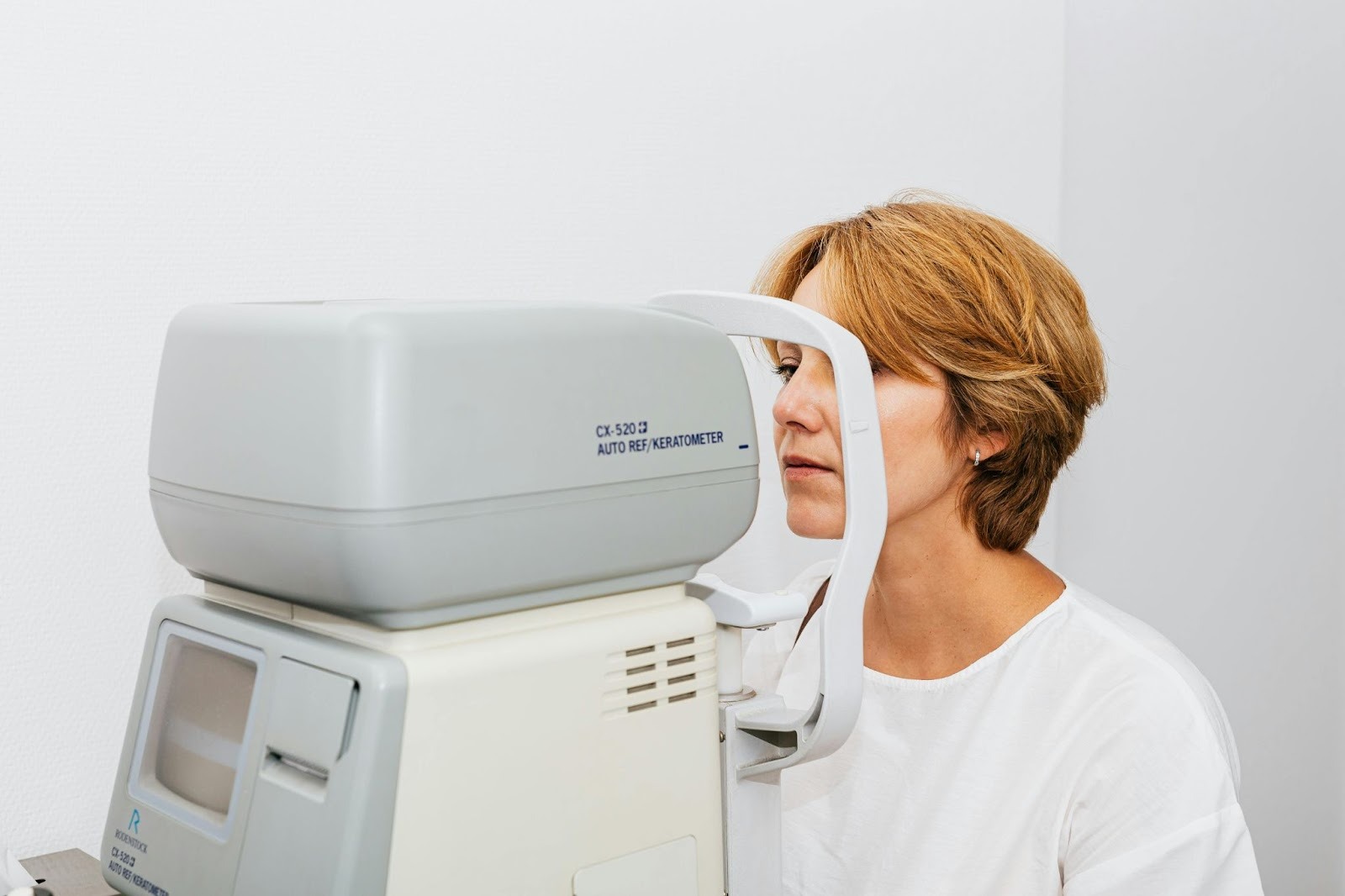 A Woman in White Blouse Having an Eye Examination