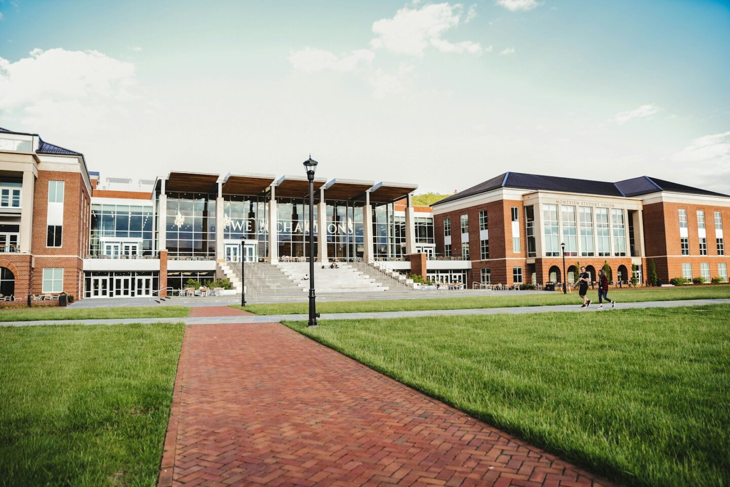 brown and white school concrete building with grass and path