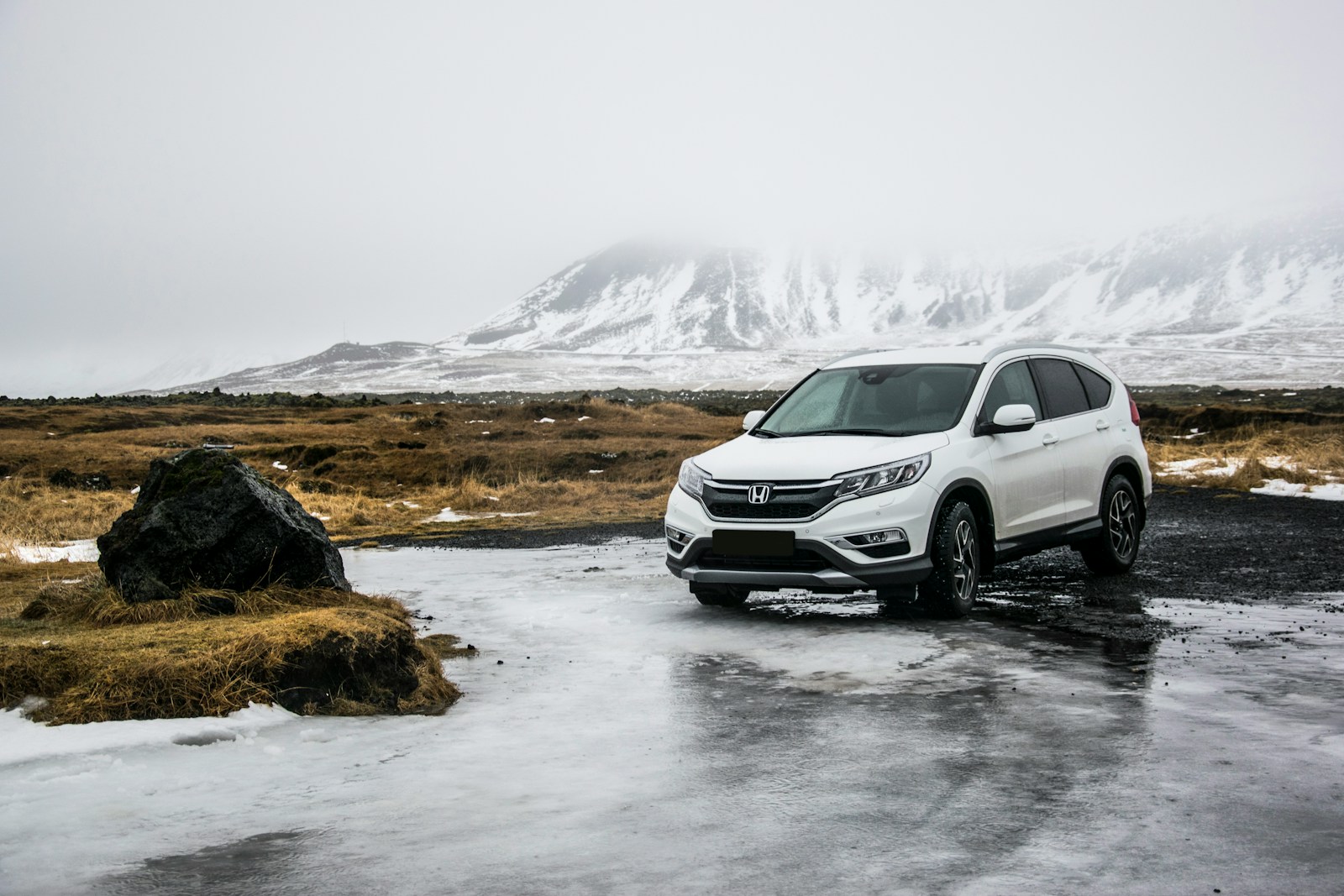 white Honda SUV on land and water